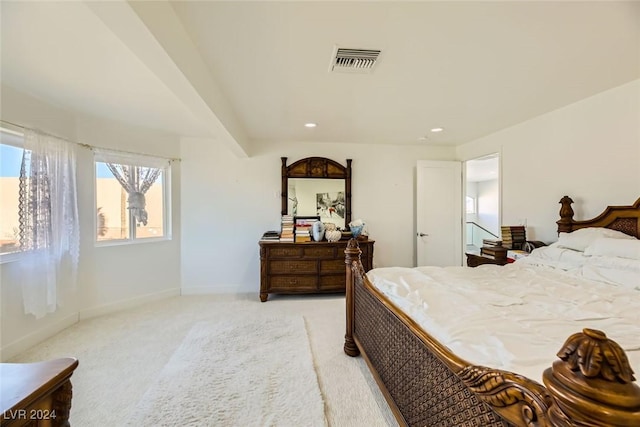 carpeted bedroom with beamed ceiling