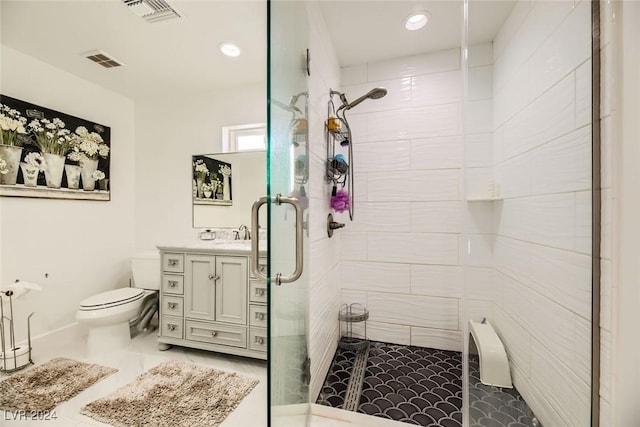 bathroom with toilet, an enclosed shower, and vanity