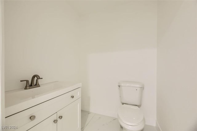 bathroom with toilet and vanity