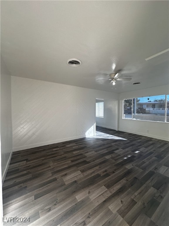 empty room featuring ceiling fan and dark wood-type flooring