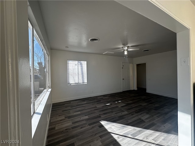 empty room featuring ceiling fan and dark wood-type flooring