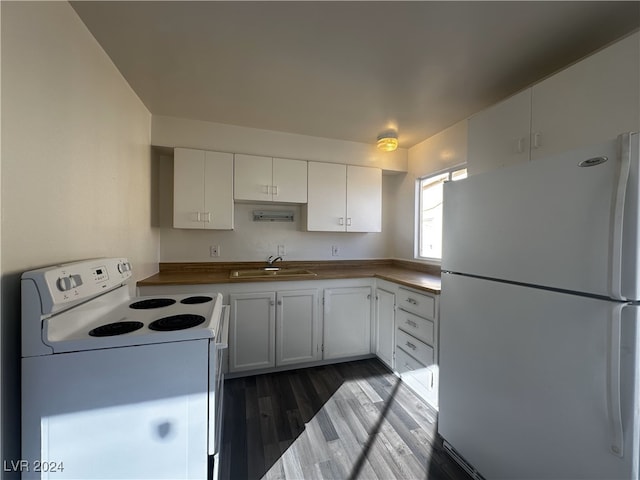 kitchen with sink, white appliances, white cabinets, and dark wood-type flooring