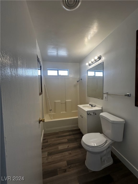 full bathroom with toilet, hardwood / wood-style flooring, bathing tub / shower combination, and vanity