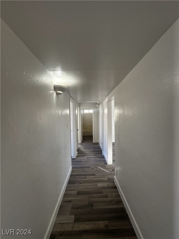 corridor with dark hardwood / wood-style floors