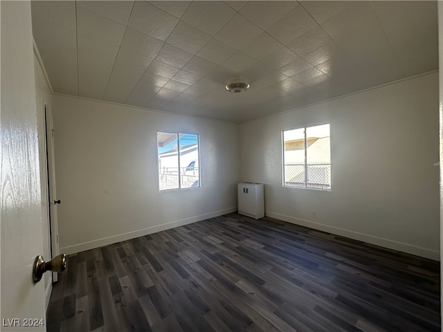 empty room with dark hardwood / wood-style flooring