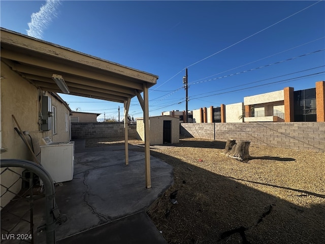 view of patio with a storage shed