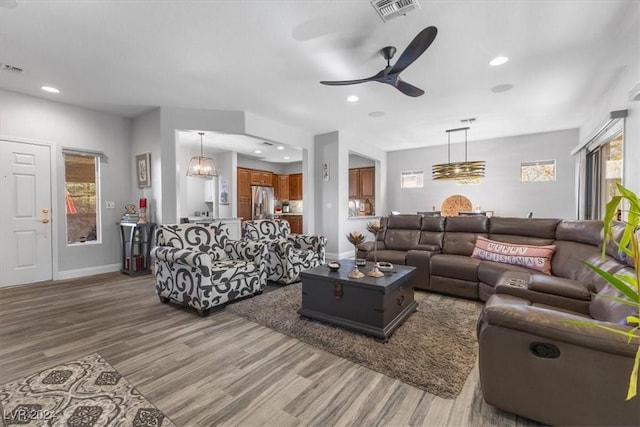 living room with hardwood / wood-style floors and ceiling fan