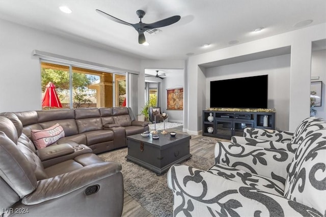 living room with ceiling fan and light wood-type flooring