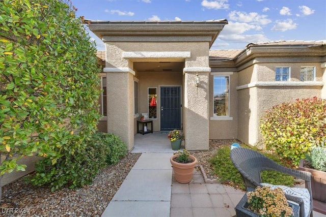 entrance to property with a patio