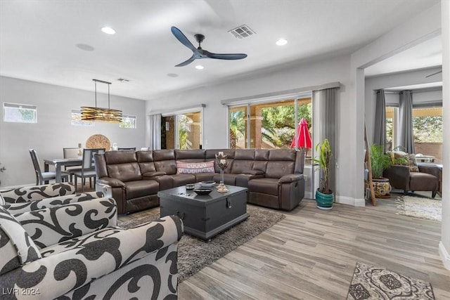 living room featuring ceiling fan and light wood-type flooring