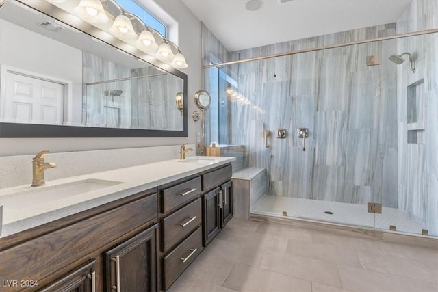 bathroom featuring vanity, a shower with door, and tile patterned floors