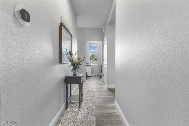 hallway with hardwood / wood-style floors