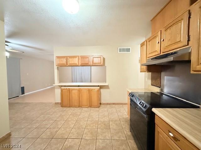 kitchen with light tile patterned floors, black range with electric stovetop, and ceiling fan