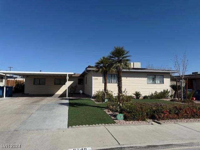 ranch-style house with an attached carport and driveway