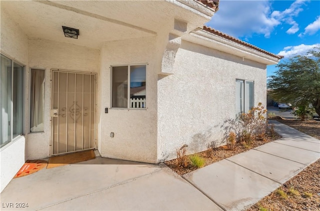 entrance to property with a patio