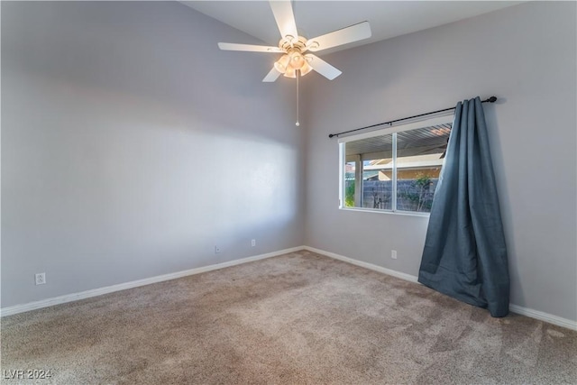 carpeted empty room featuring ceiling fan and vaulted ceiling