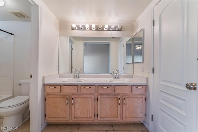 bathroom with tile patterned flooring, vanity, and toilet