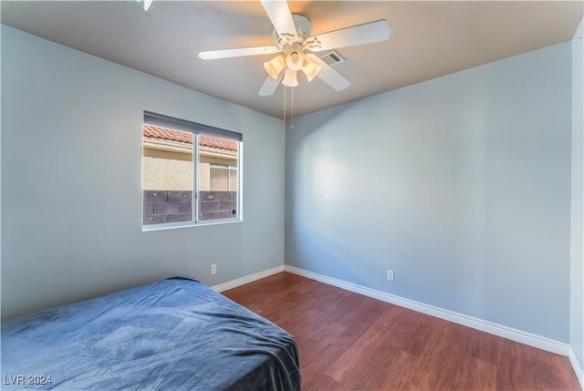 bedroom featuring ceiling fan and dark hardwood / wood-style floors