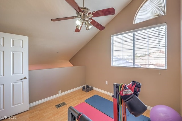 workout room featuring lofted ceiling, ceiling fan, and hardwood / wood-style flooring