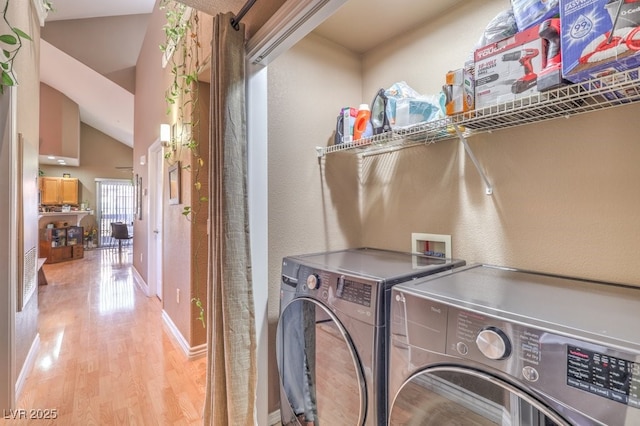 clothes washing area with separate washer and dryer and light hardwood / wood-style flooring