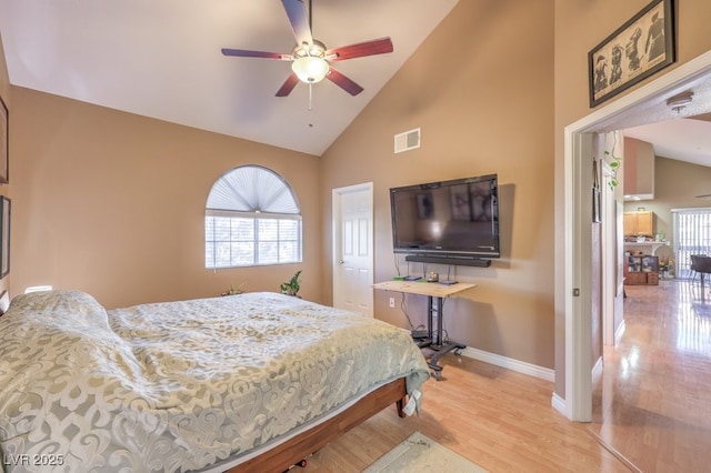 bedroom with high vaulted ceiling, ceiling fan, and light hardwood / wood-style floors