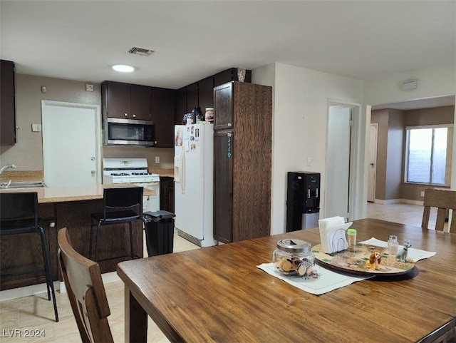 dining room featuring sink and light wood-type flooring