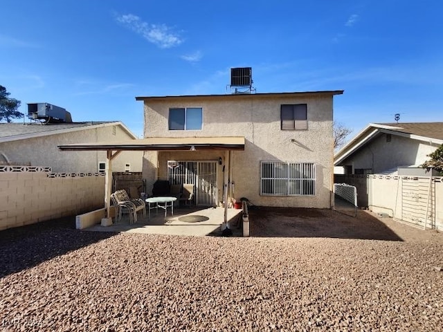 rear view of property featuring a patio area and central air condition unit