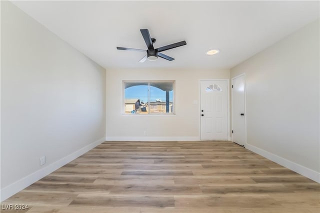 spare room featuring light hardwood / wood-style flooring and ceiling fan