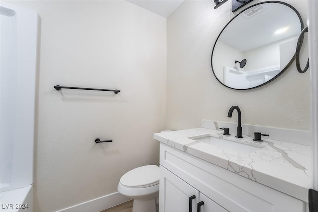 bathroom with vanity and toilet