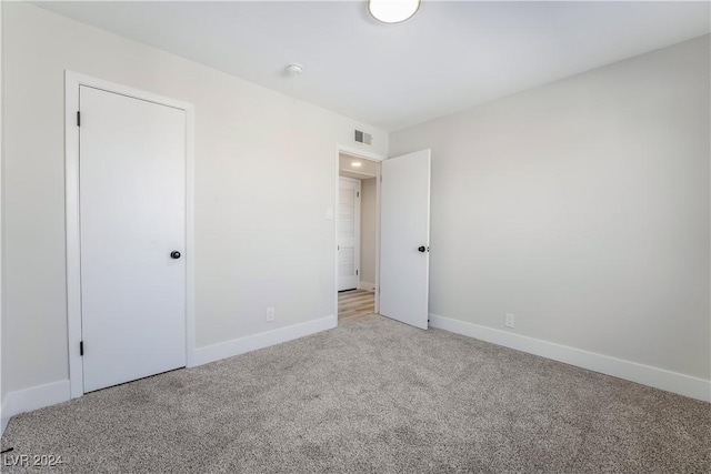 unfurnished bedroom with light colored carpet