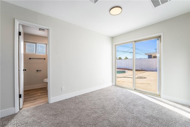 carpeted spare room featuring a healthy amount of sunlight