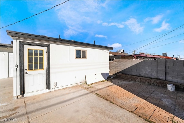 view of side of home with a patio area