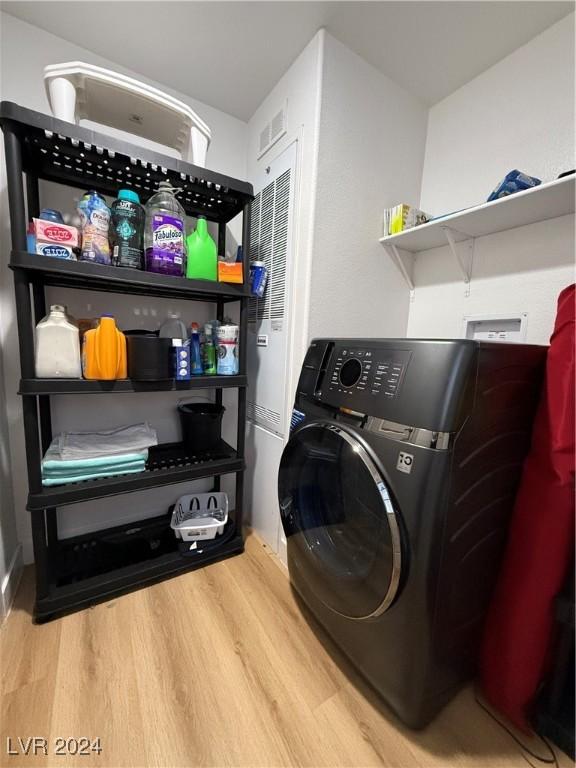 washroom with washer / dryer and hardwood / wood-style flooring