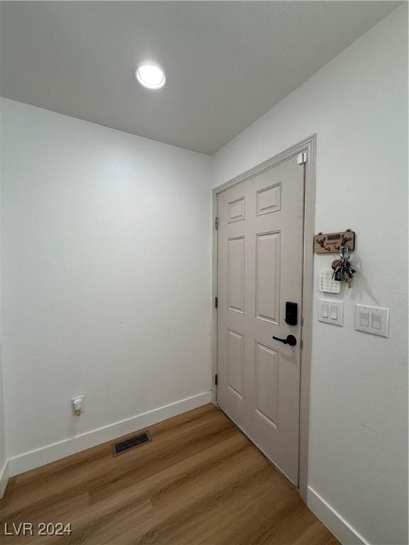 doorway to outside with wood-type flooring