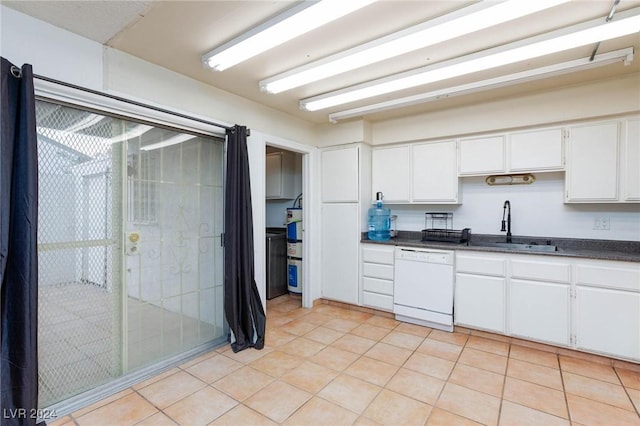 kitchen featuring dishwasher, light tile patterned flooring, white cabinetry, and sink