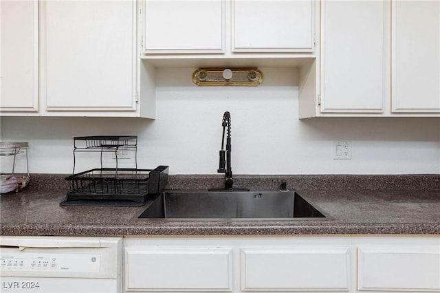 kitchen with dishwasher, sink, and white cabinets