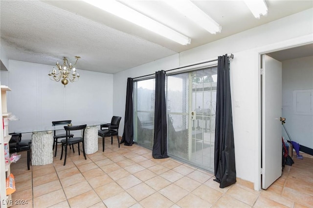 dining area featuring light tile patterned floors and a notable chandelier