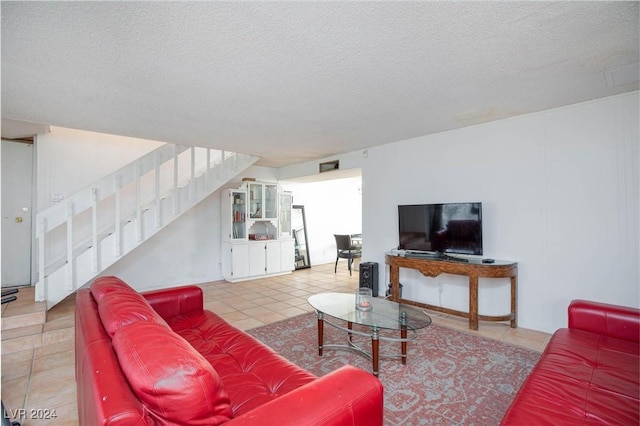 living room with tile patterned flooring and a textured ceiling