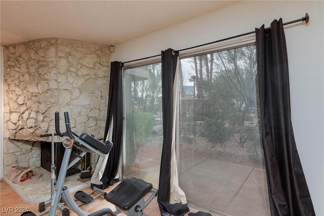 exercise room with wood-type flooring and a textured ceiling