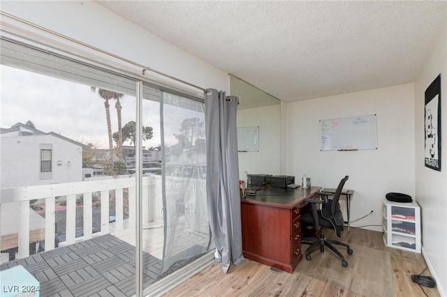 office featuring a textured ceiling and light hardwood / wood-style floors