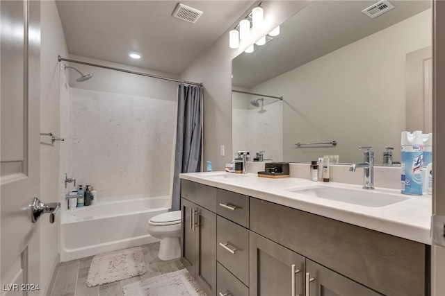 full bathroom featuring hardwood / wood-style flooring, shower / bath combination with curtain, toilet, and vanity