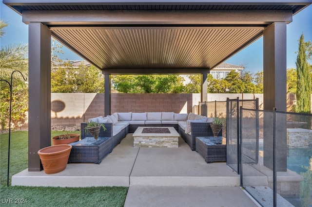 view of patio featuring an outdoor living space with a fire pit