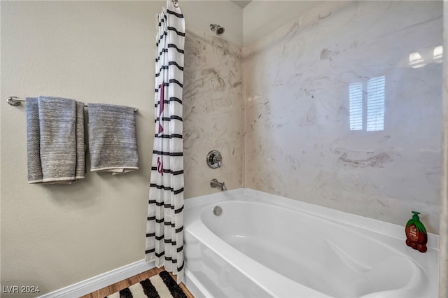 bathroom featuring hardwood / wood-style floors and shower / bath combo