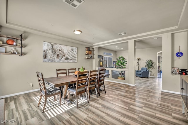 dining space with light hardwood / wood-style floors