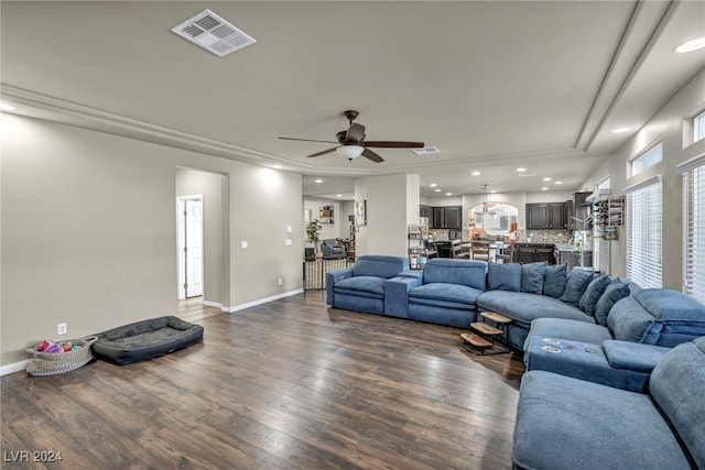 living room with ceiling fan and dark hardwood / wood-style floors