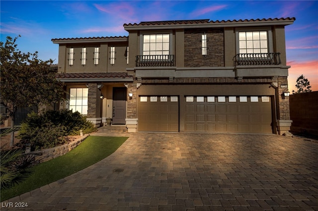 mediterranean / spanish-style house featuring a balcony and a garage