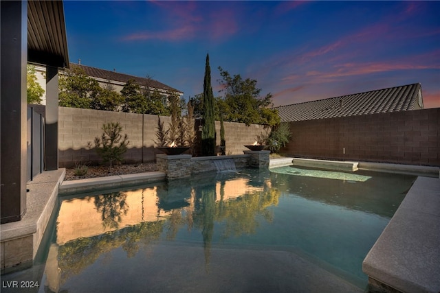 view of pool at dusk