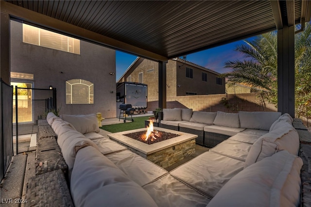 patio terrace at dusk featuring an outdoor fire pit