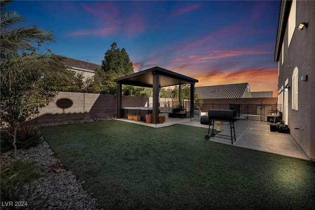 yard at dusk with a patio area and outdoor lounge area