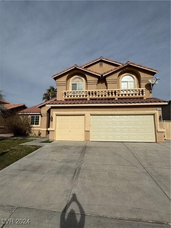 mediterranean / spanish home with a garage